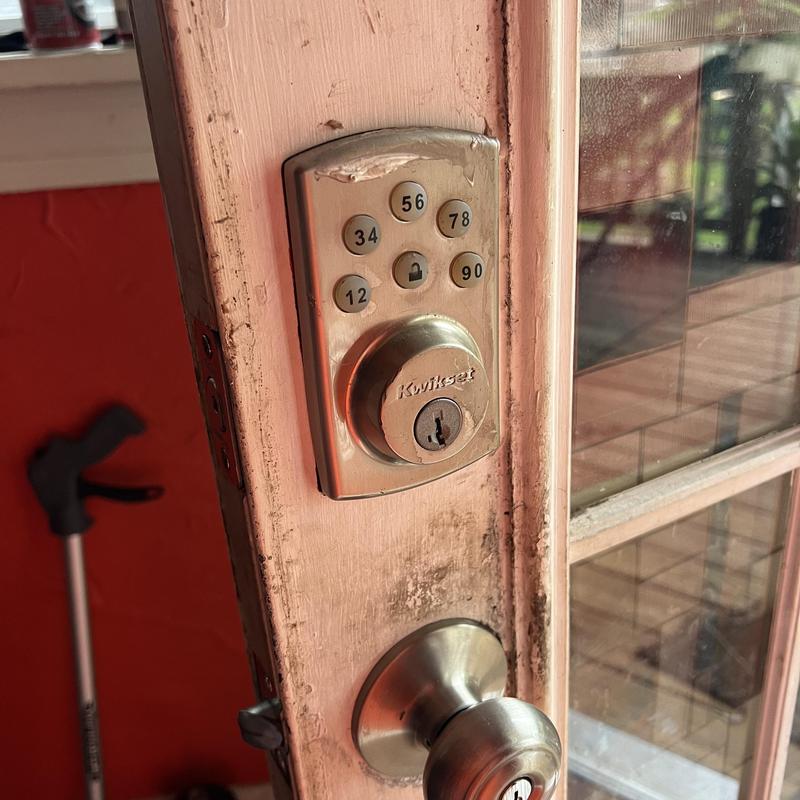 Electronic keypad lock and door knob on wooden door