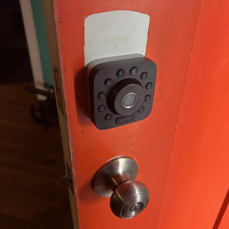 Electronic keypad lock on orange door