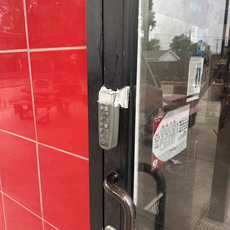 Electronic keypad on glass door with tape seal Electronic keypad on glass door with tape seal
