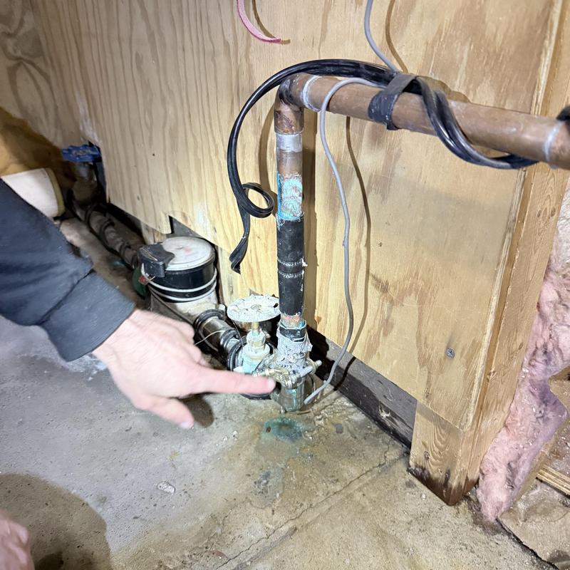 Main water shut off valve and piping installation near floor
