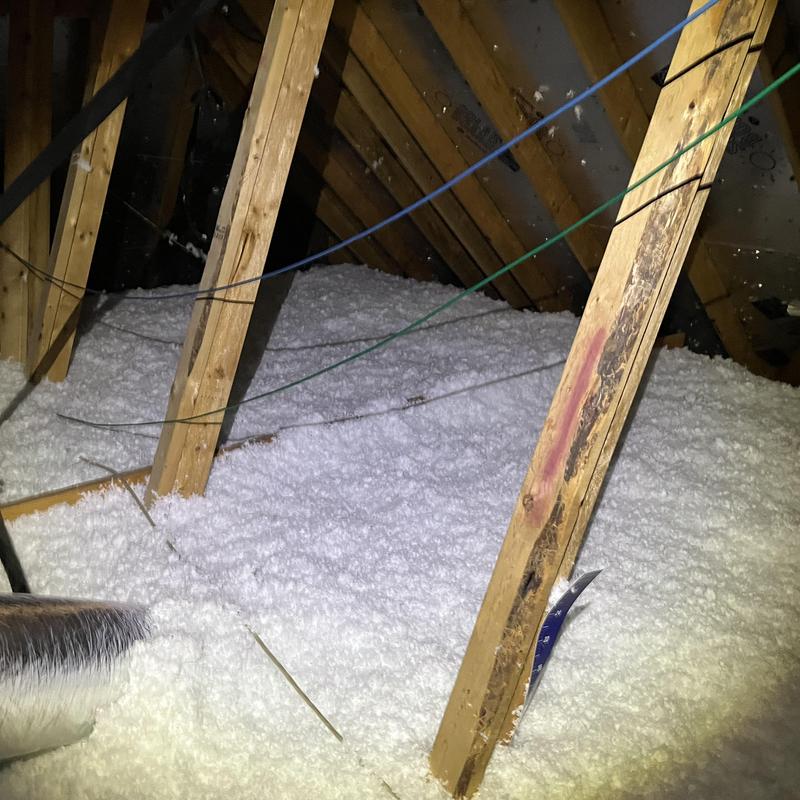 Attic insulation with loose-fill foam in wooden frame attic