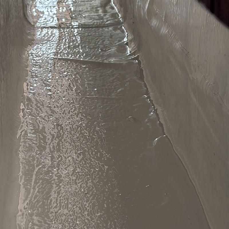 Silicone roof coating curing on flat roof surface