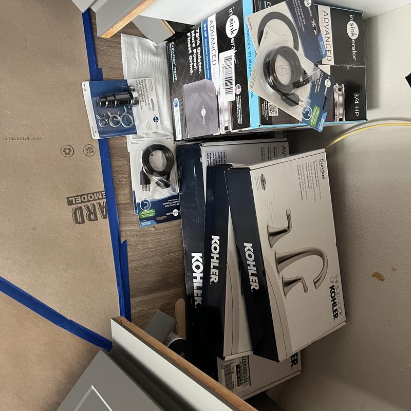 Kitchen faucet and garbage disposal installation parts boxes