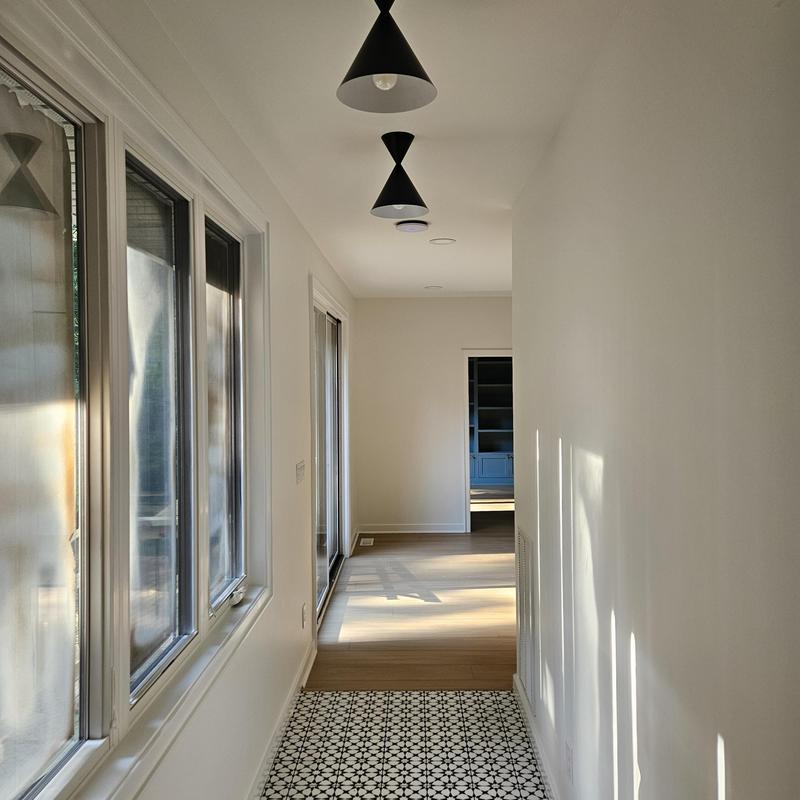 Decorative tile floor in hallway with natural light Decorative tile floor in hallway with natural light