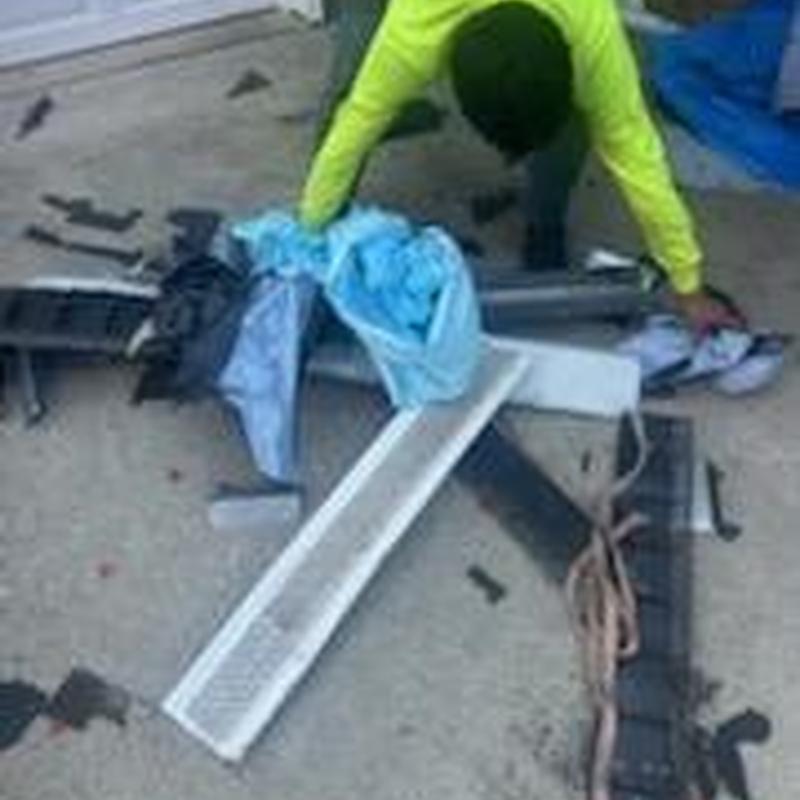 Gutter guard installation materials with worker in safety gear Gutter guard installation materials with worker in safety gear