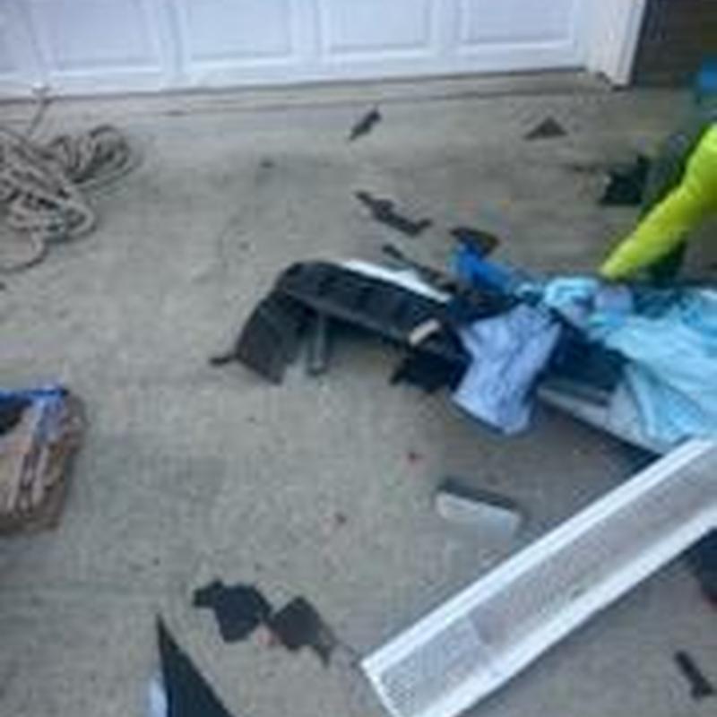 Garage door panel replacement materials and debris on driveway Garage door panel replacement materials and debris on driveway