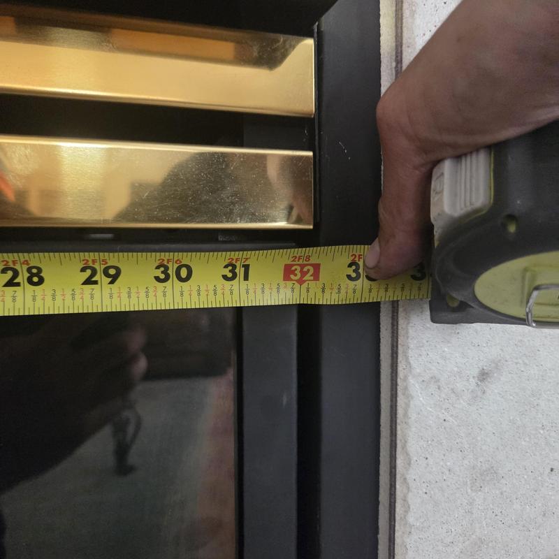 Fireplace frame measuring with tape at 32 inches Fireplace frame measuring with tape at 32 inches