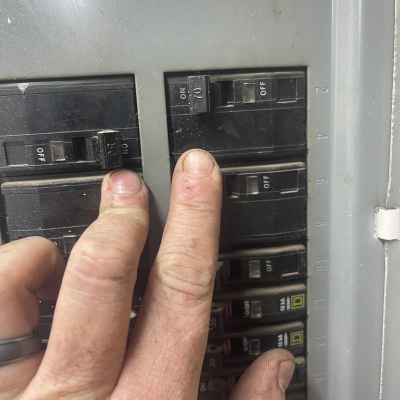 Circuit breakers in electrical panel being inspected Circuit breakers in electrical panel being inspected