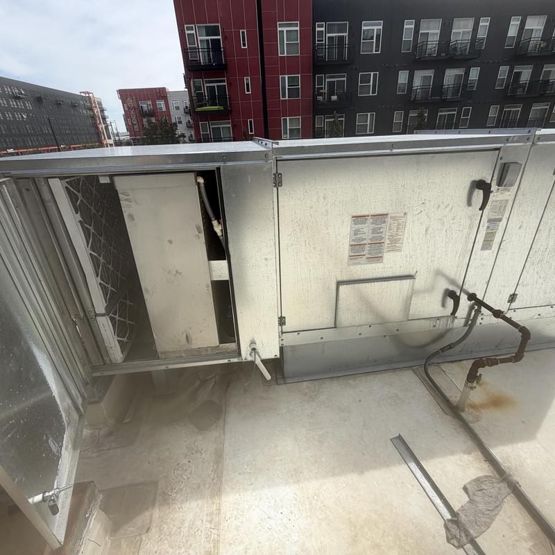 Swamp cooler unit with open access panel on rooftop Swamp cooler unit with open access panel on rooftop