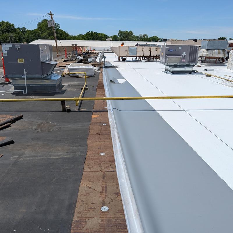 TPO single ply roofing installation on flat commercial roof TPO single ply roofing installation on flat commercial roof