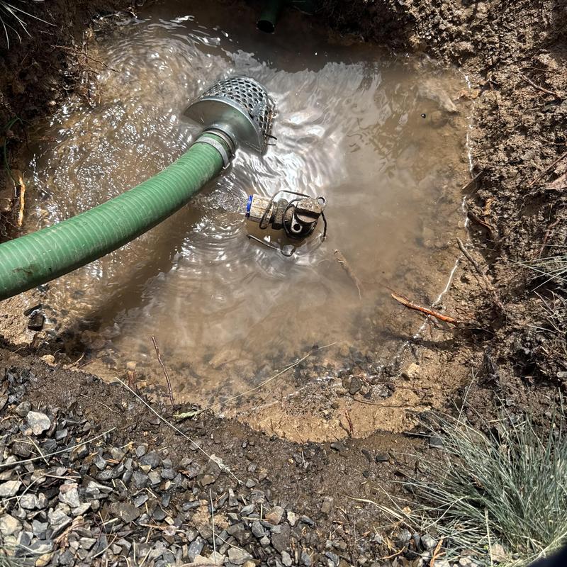 Curb stop valve and irrigation hose in muddy water