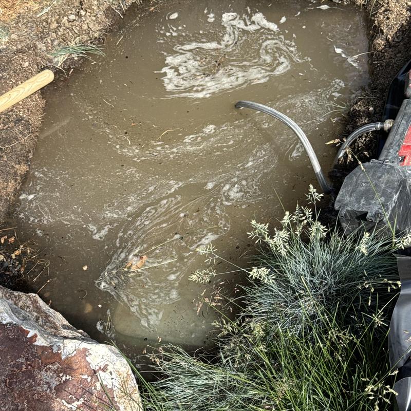 Irrigation curb stop valve excavation and water drainage