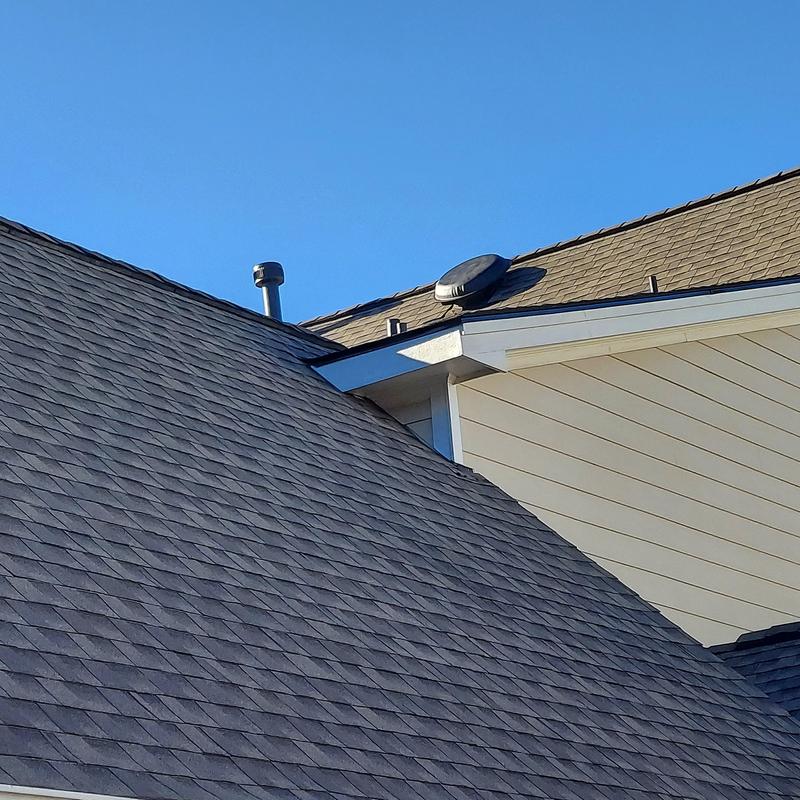 Asphalt shingle roof with vent and siding on house Asphalt shingle roof with vent and siding on house