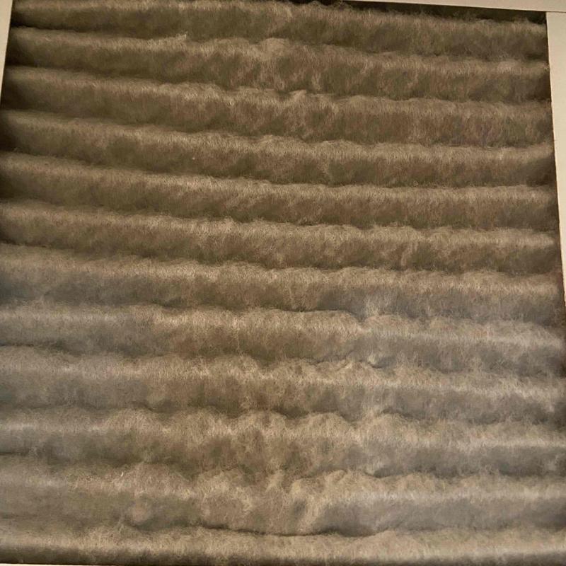 HVAC air filter heavily clogged with dust buildup HVAC air filter heavily clogged with dust buildup