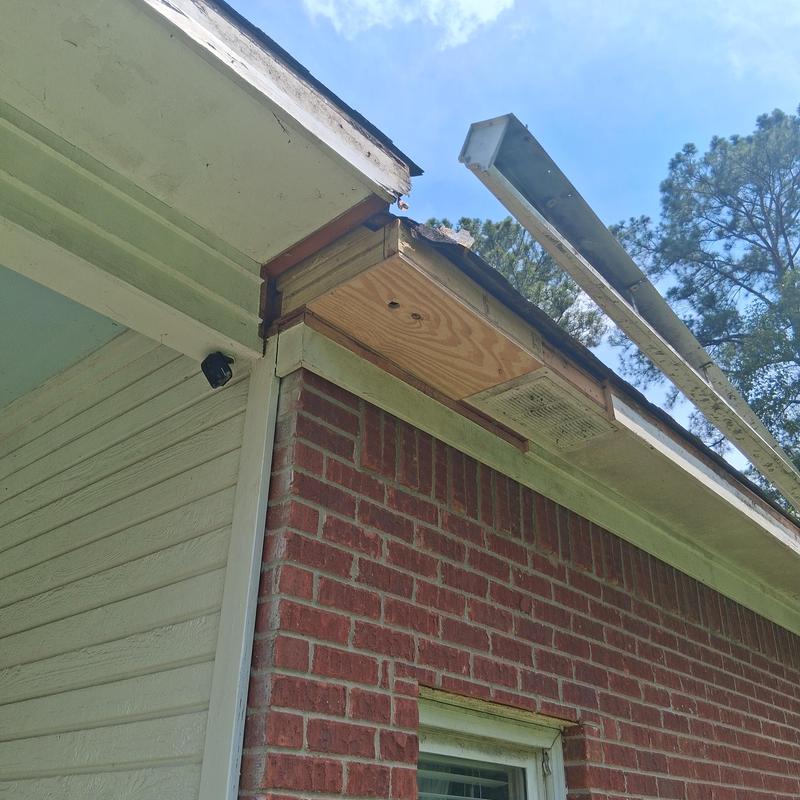 Soffit and fascia repair on brick and wood house exterior