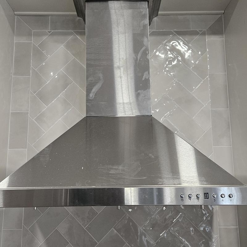 Stainless steel kitchen range hood with tile backsplash Stainless steel kitchen range hood with tile backsplash