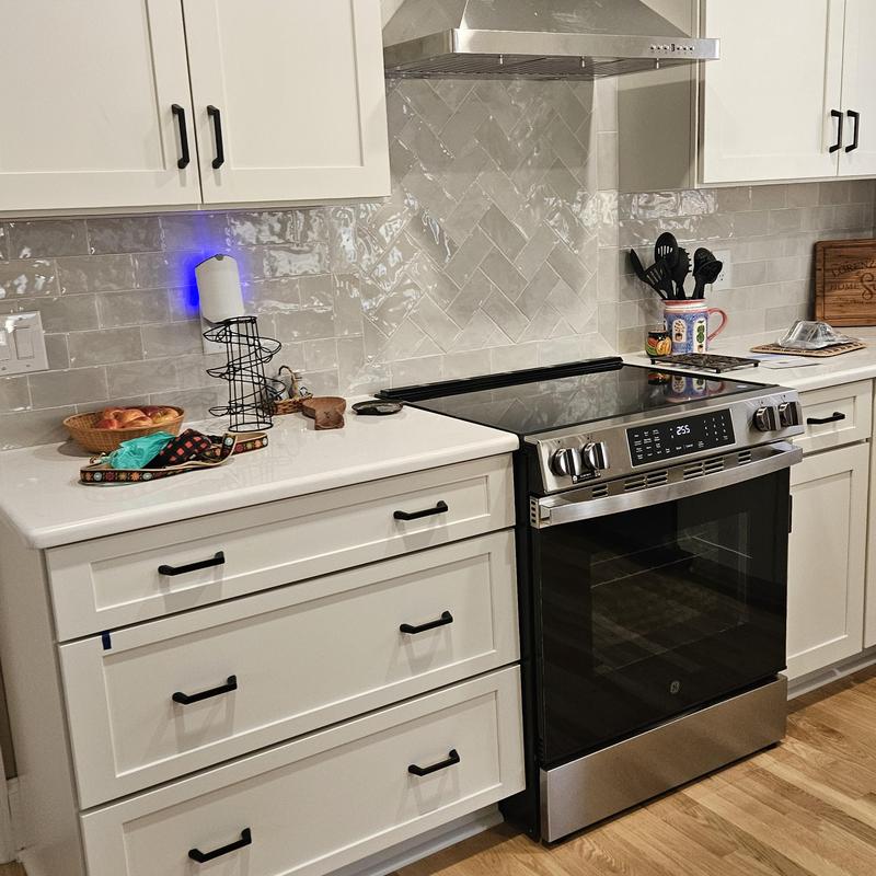 Electric stove with stainless steel range hood and cabinets Electric stove with stainless steel range hood and cabinets