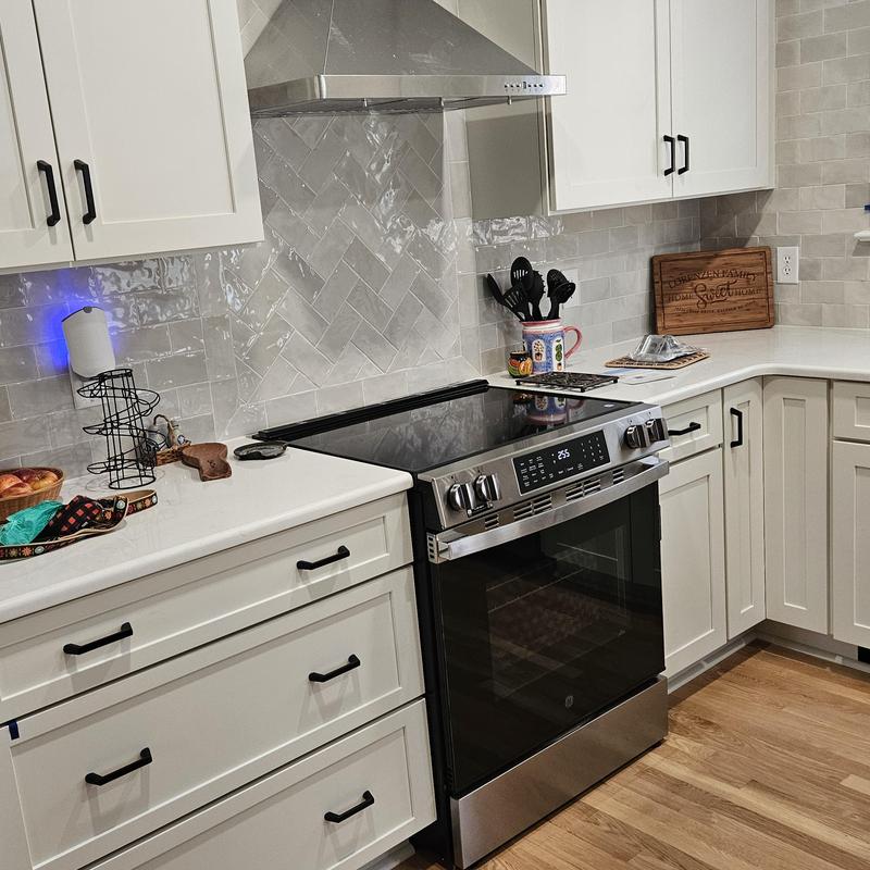 Electric stove with hood and white cabinetry Electric stove with hood and white cabinetry