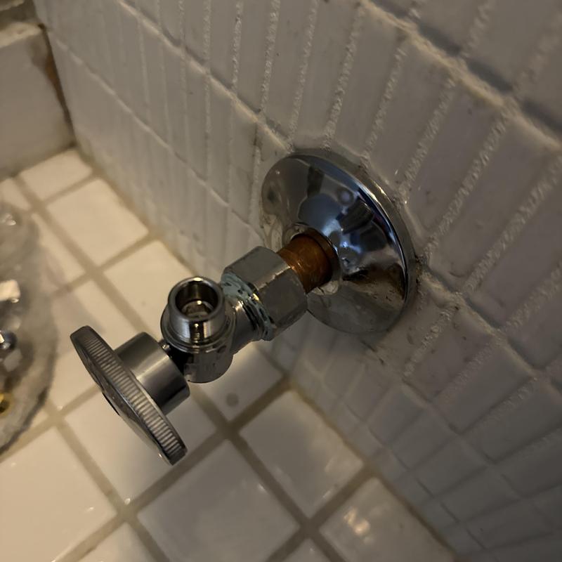 Toilet angle stop valve installation on tiled wall