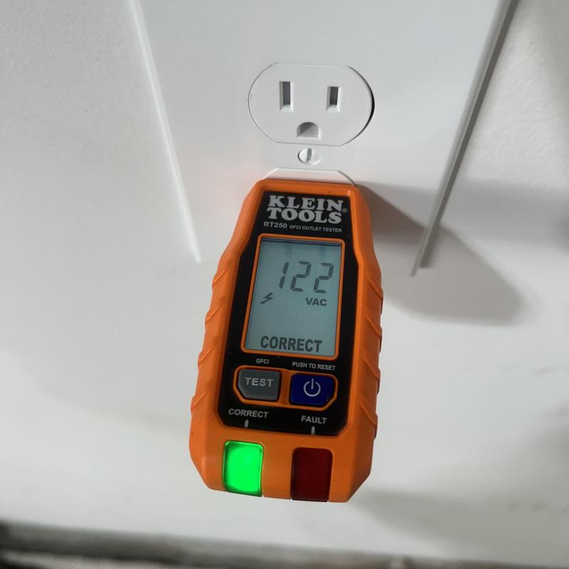 GFCI outlet with voltage tester showing 122 VAC GFCI outlet with voltage tester showing 122 VAC