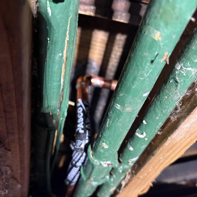 Copper hot water line with new fittings in ceiling slot
