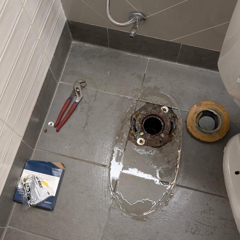 Toilet flange and seal removed on tiled floor Toilet flange and seal removed on tiled floor