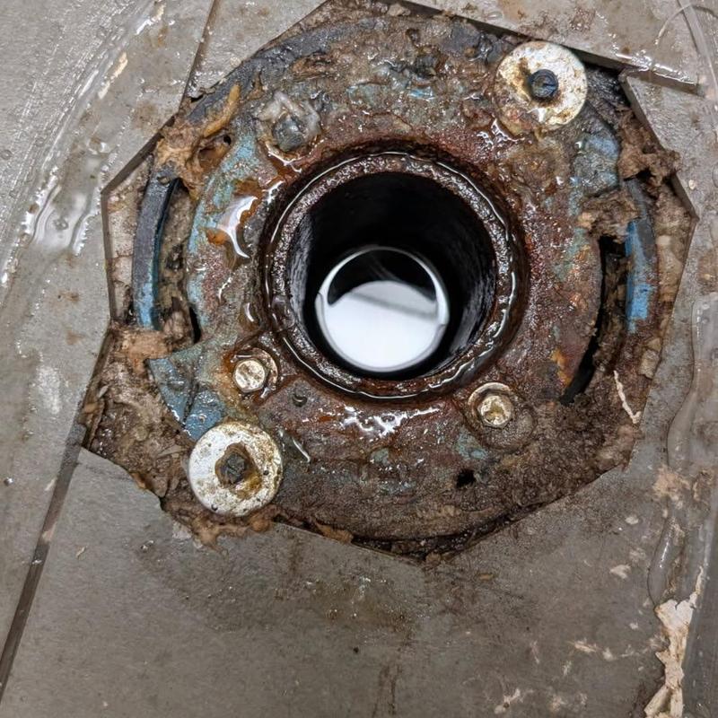 Toilet flange corrosion and main drain opening on tiled floor Toilet flange corrosion and main drain opening on tiled floor