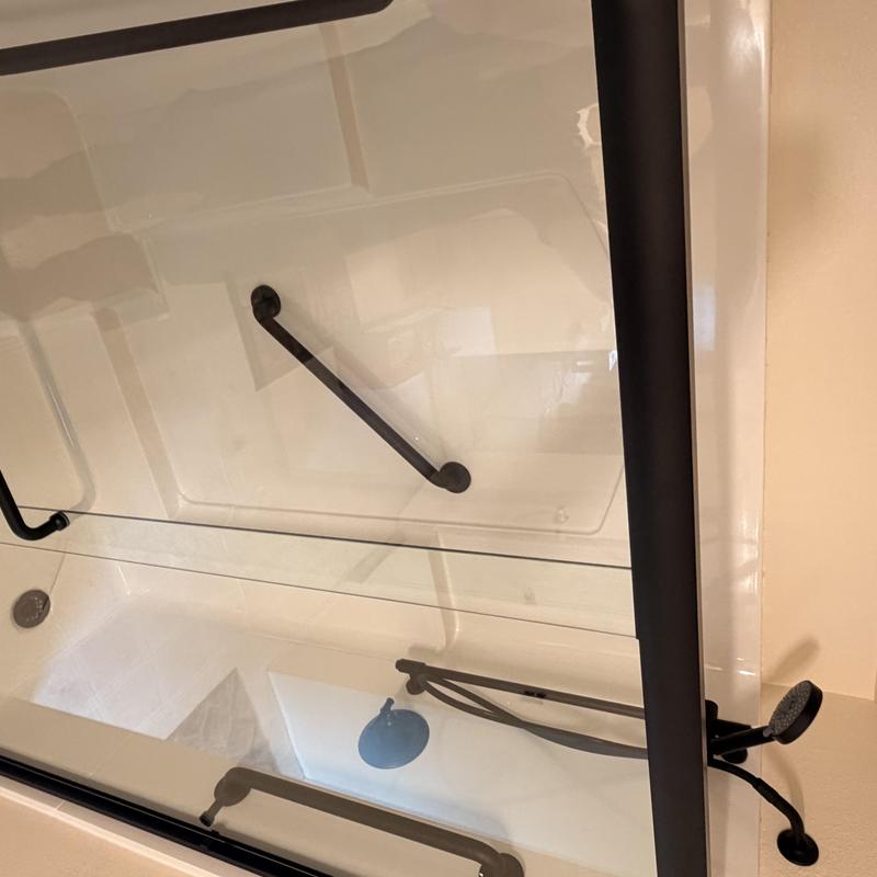 Three-piece shower stall with matte black fixtures and door
