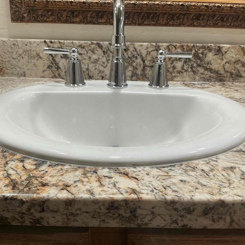 Bathroom sink faucet with chrome handles installed