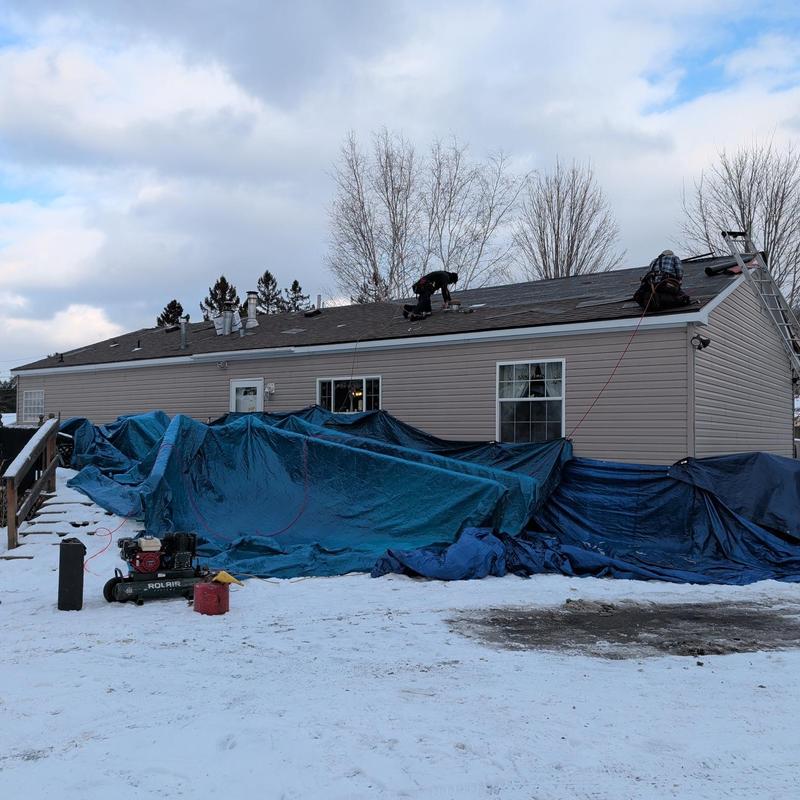 Asphalt shingle roof installation with snow tarps