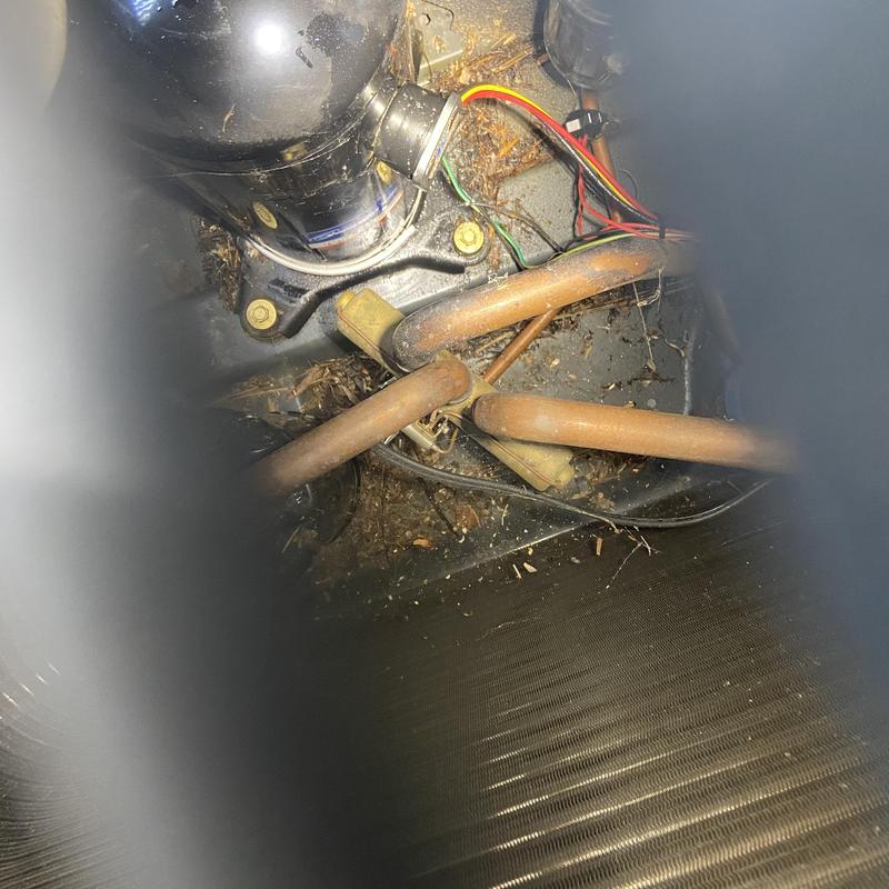 HVAC unit compressor and copper tubing with wiring and debris HVAC unit compressor and copper tubing with wiring and debris