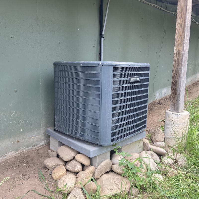 HVAC outdoor condenser unit on concrete pad HVAC outdoor condenser unit on concrete pad