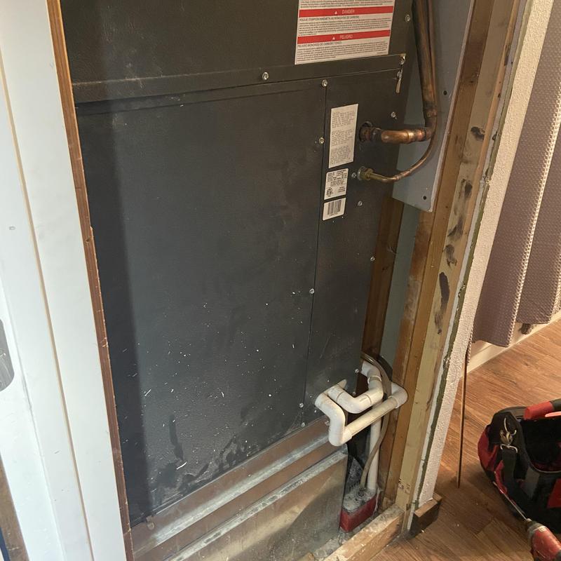 HVAC unit inspection with visible copper and PVC piping HVAC unit inspection with visible copper and PVC piping