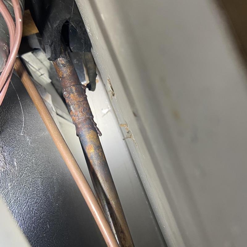 Copper HVAC refrigerant line with corrosion and rust buildup Copper HVAC refrigerant line with corrosion and rust buildup