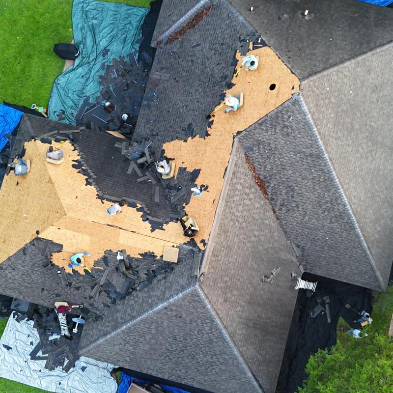 Roof shingles removal and replacement in progress