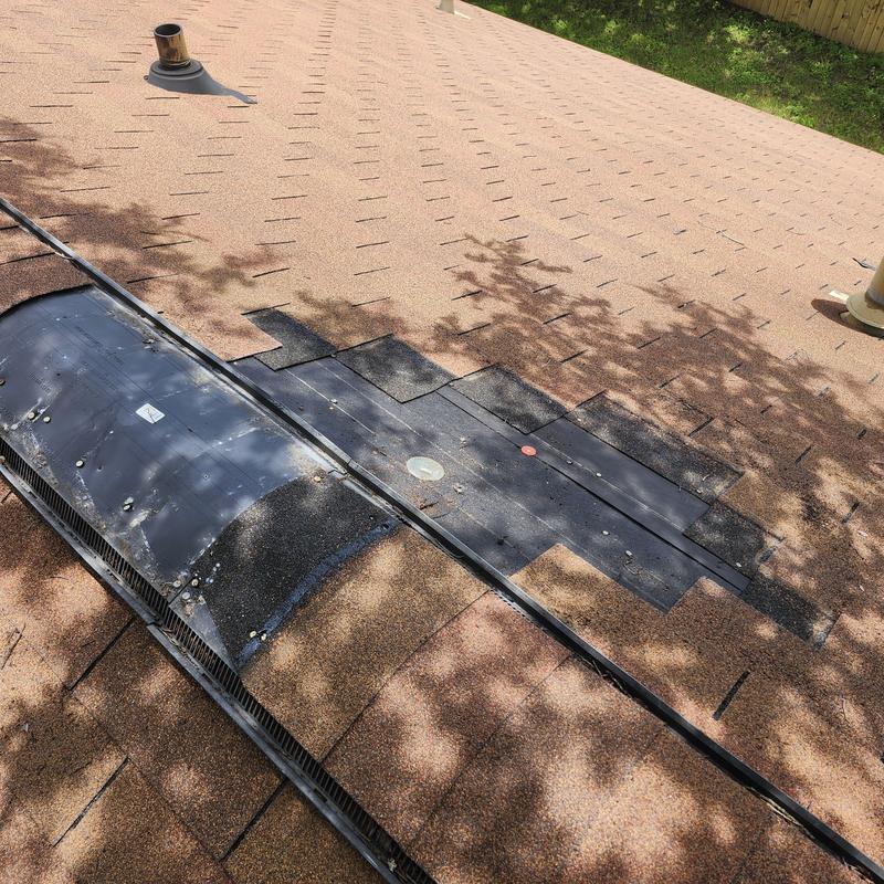Asphalt shingle roof with repaired ridge vent and flashing Asphalt shingle roof with repaired ridge vent and flashing