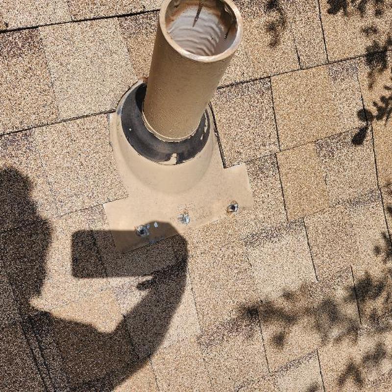 Chimney flashing with sealed fasteners on roof shingles Chimney flashing with sealed fasteners on roof shingles