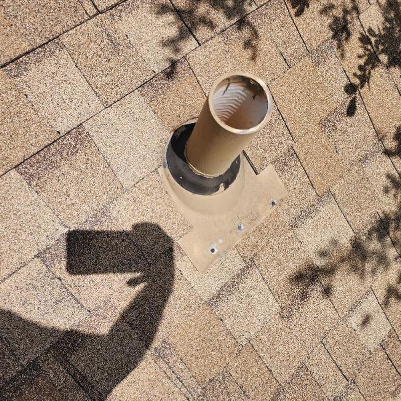 Chimney pipe flashing and sealed caulking on roof Chimney pipe flashing and sealed caulking on roof