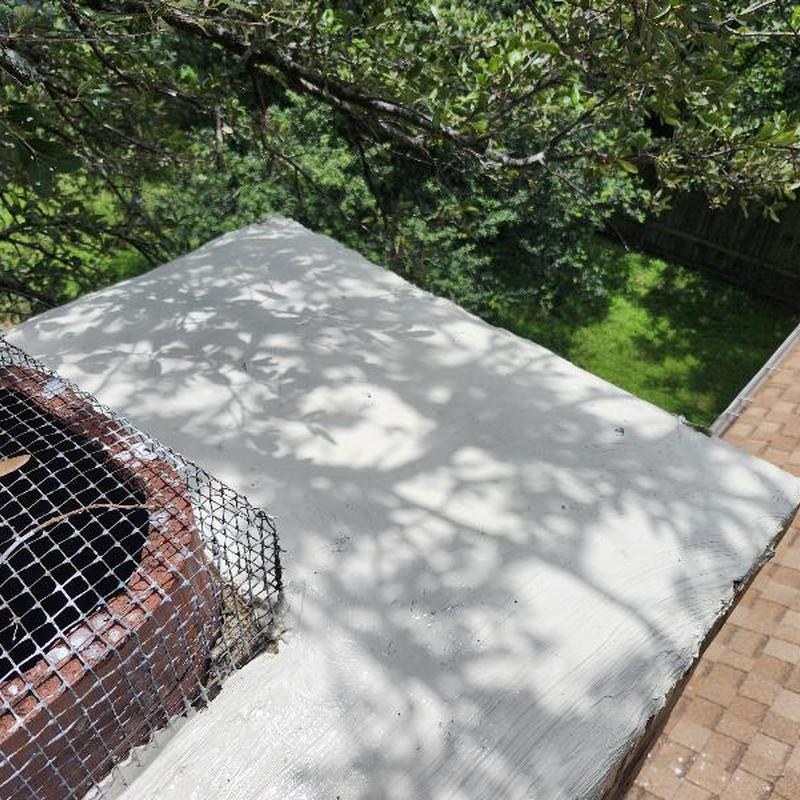 Chimney sealing and caulking with mesh guard on roof edge Chimney sealing and caulking with mesh guard on roof edge