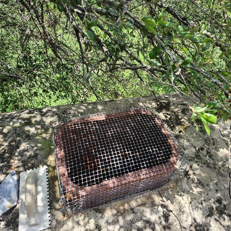 Chimney sealed with caulk and wire mesh grid Chimney sealed with caulk and wire mesh grid