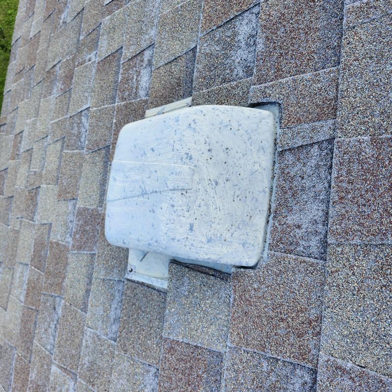 Roof shingles with hail damage around vent cover Roof shingles with hail damage around vent cover