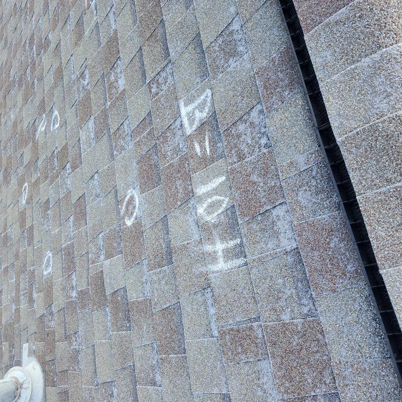 Roof shingles with chalk-marked hail damage inspection Roof shingles with chalk-marked hail damage inspection