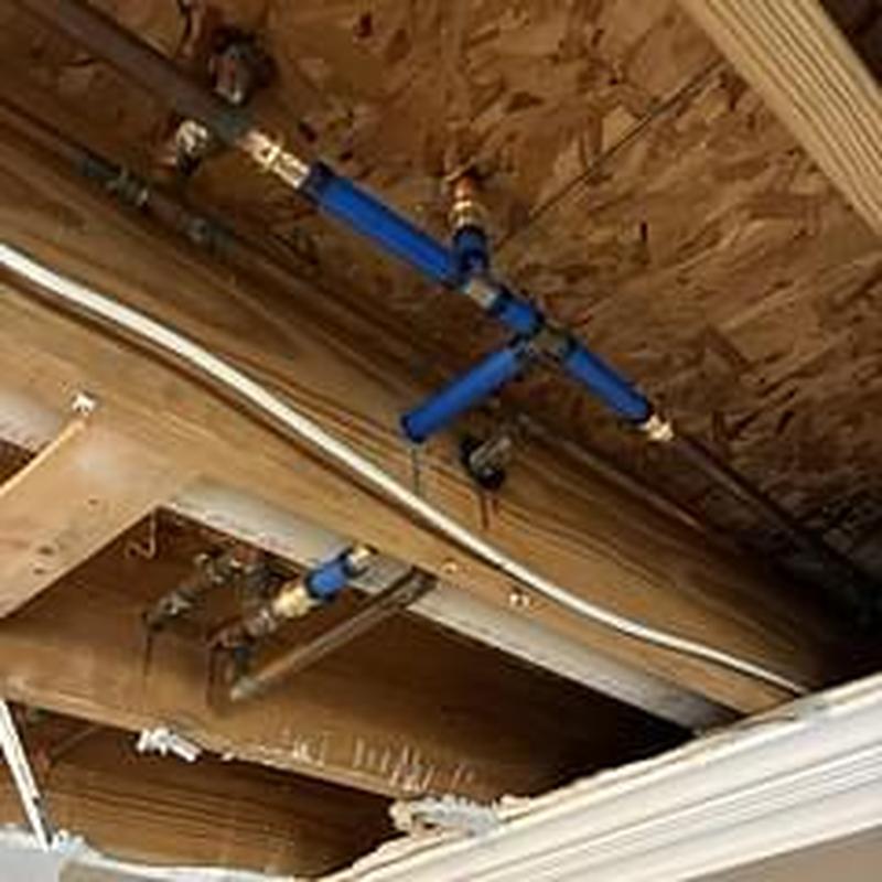 Cold water feed PEX piping with new fittings installed Cold water feed PEX piping with new fittings installed