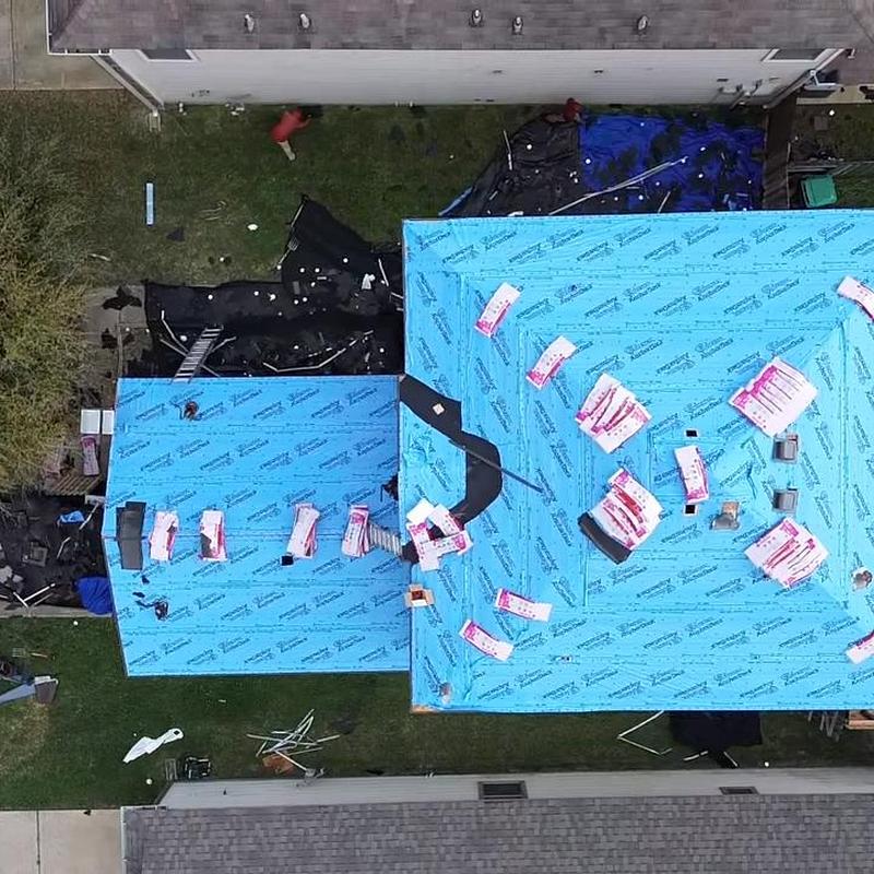 Roof underlayment installation with materials staged