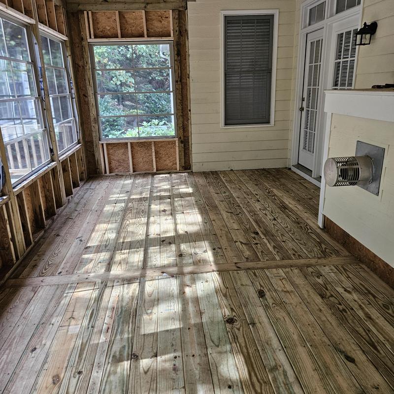 Wooden deck flooring with framed window walls Wooden deck flooring with framed window walls