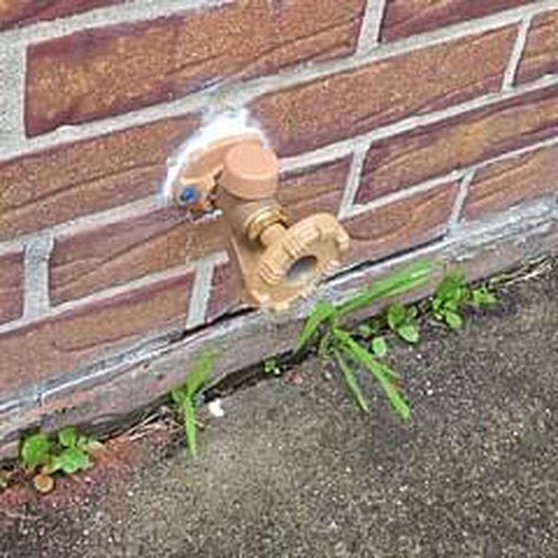 Hose bib with new installation on brick wall Hose bib with new installation on brick wall