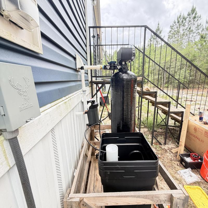 Whole home water filtration system installation outdoors