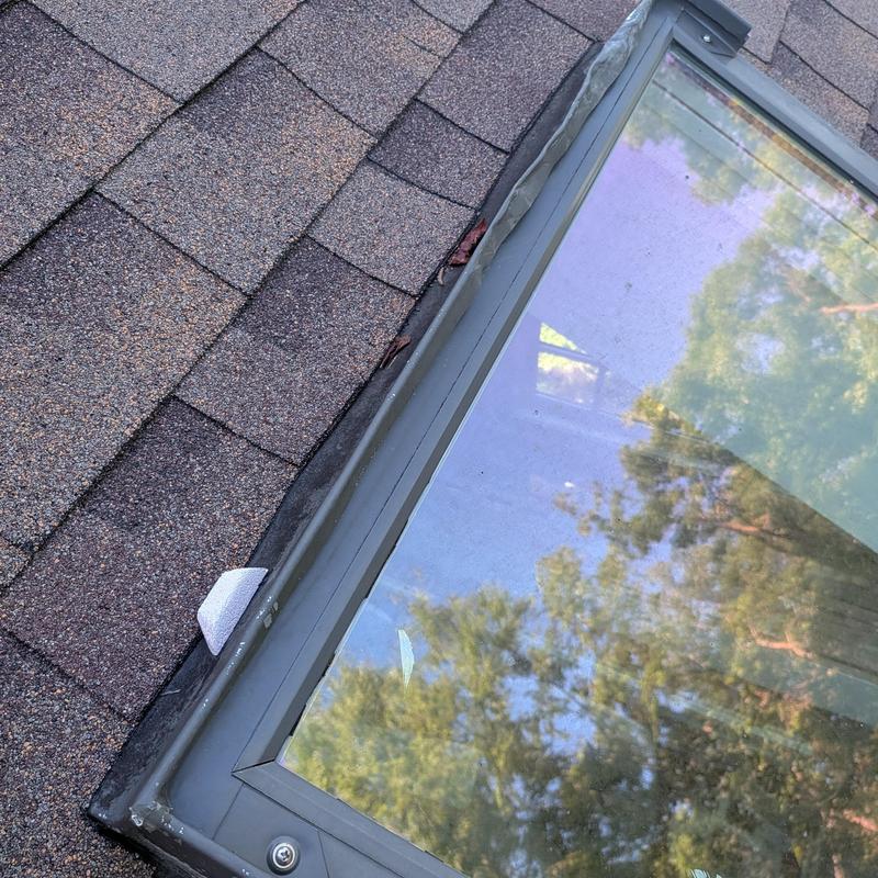 Roof skylight with asphalt shingle flashing installation
