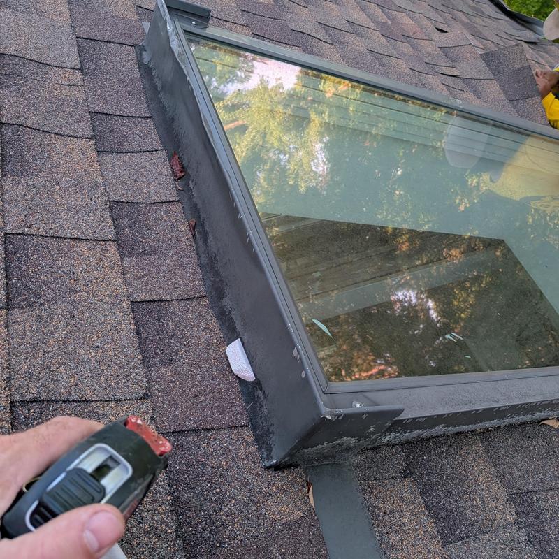Roof skylight with installed flashing and shingles