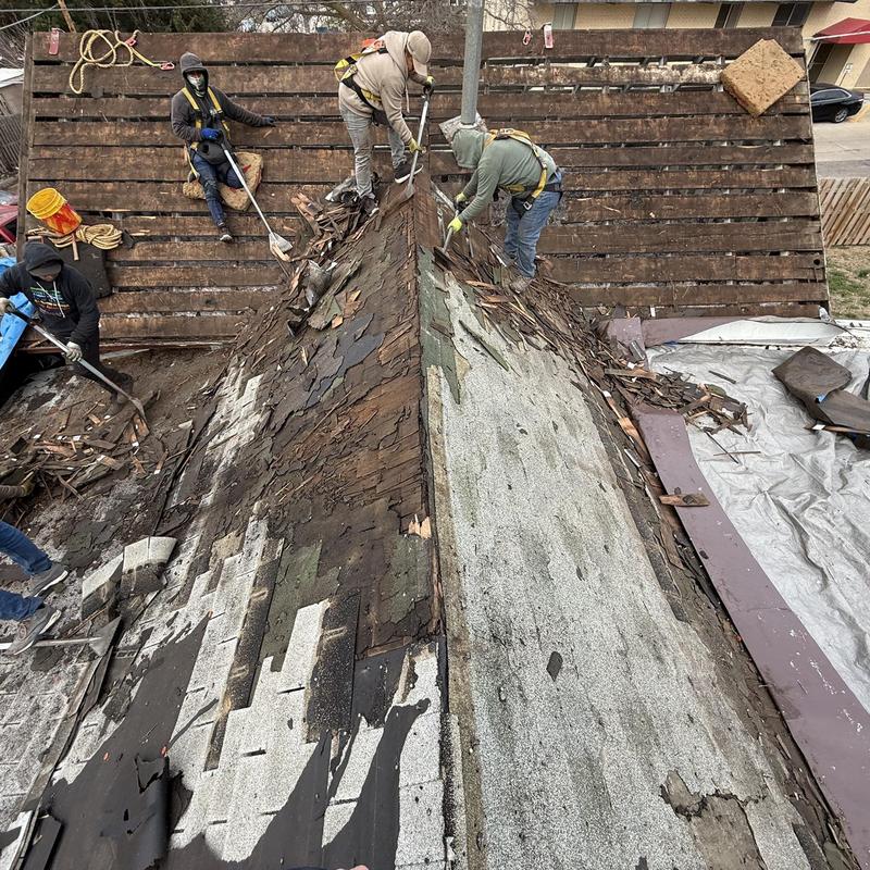Roof shingles removal on damaged steep roof slope